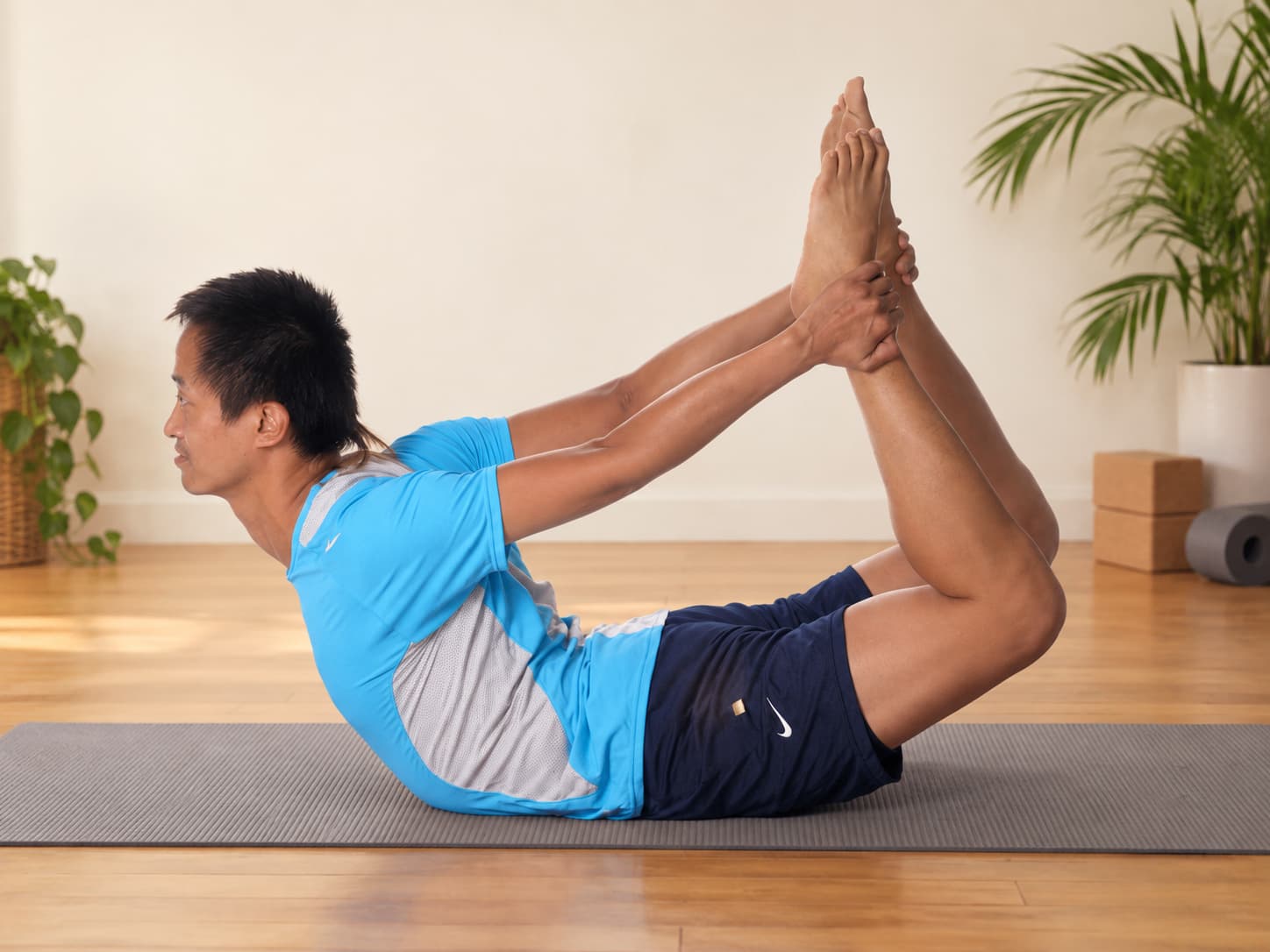 Practicing bow pose indoors