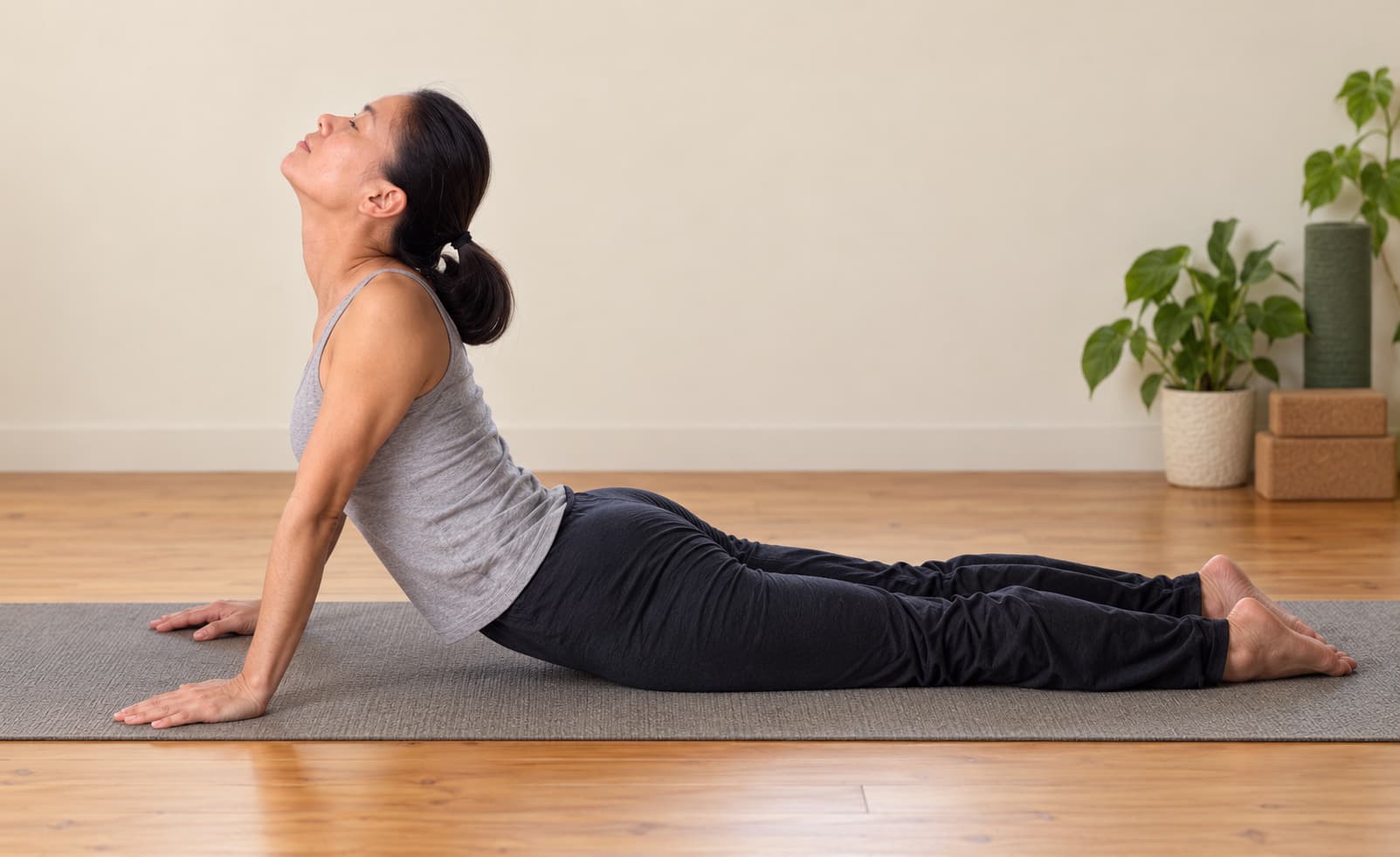 A person practicing cobra pose indoors